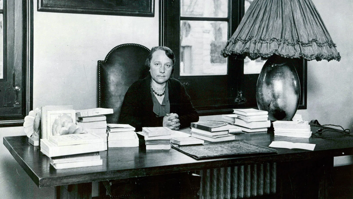 Mujer sentada en la mesa de su despacho.